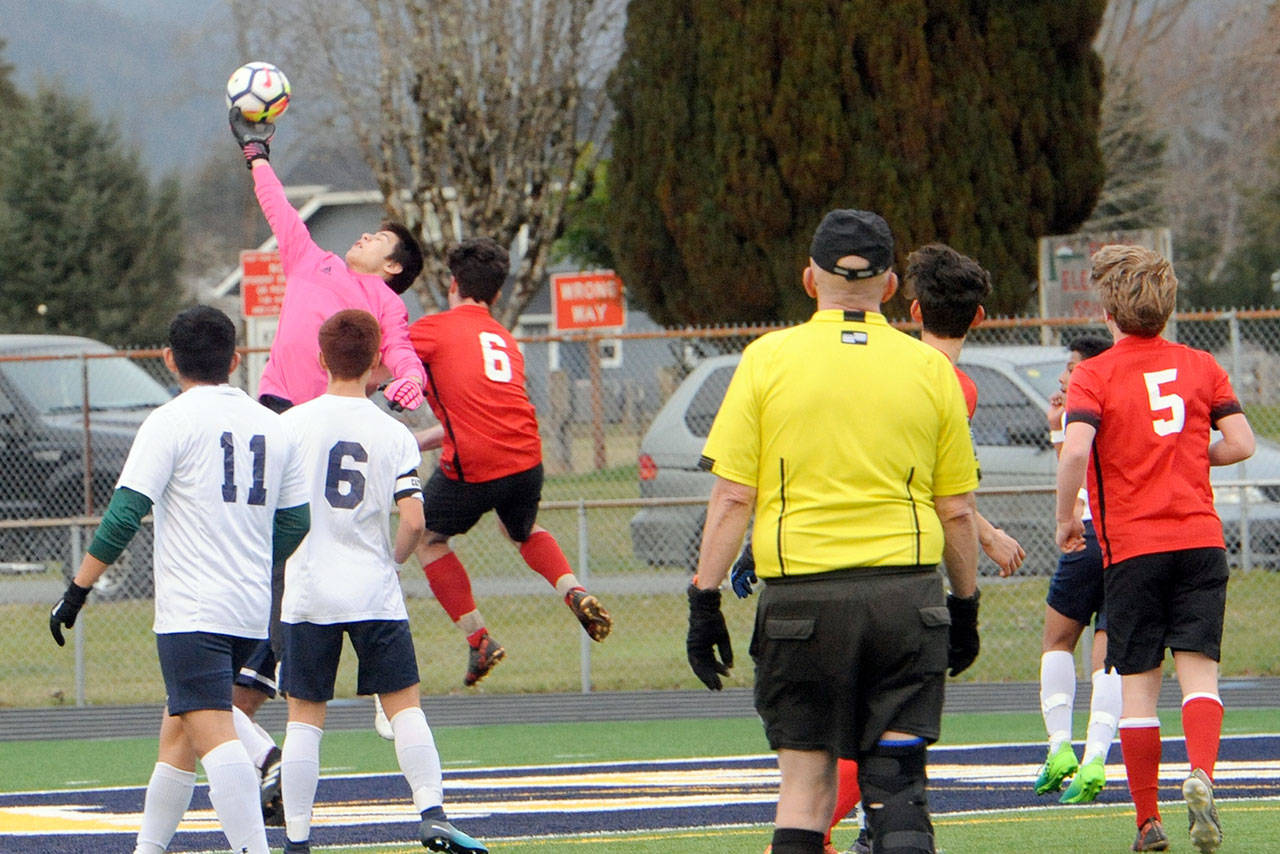 Lonnie Archibald/for Peninsula Daily News Forks goalkeeper Gabriel Terrones (in pink) leaps to make a save in the Spartans’ 3-0 shutout victory over Port Townsend on Wednesday at Spartan Stadium in Forks.