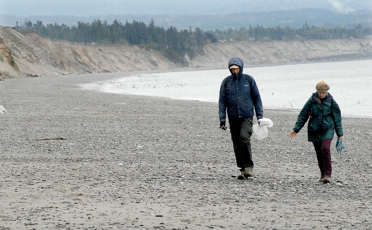 File photo by &lt;strong&gt;Keith Thorpe&lt;/strong&gt;/Peninsula Daily News                                George and Jolie Will of Sequim look for litter on the beach near the Dungeness National Wildlife Refuge near Sequim in 2017, as part of a statewide effort to remove trash and other unwanted debris from along Washington’s coasts. The event, hosted by the Washington CoastSavers program, sees volunteers each year spread out to scour beaches along the Pacific coastline and the Strait of Juan de Fuca.