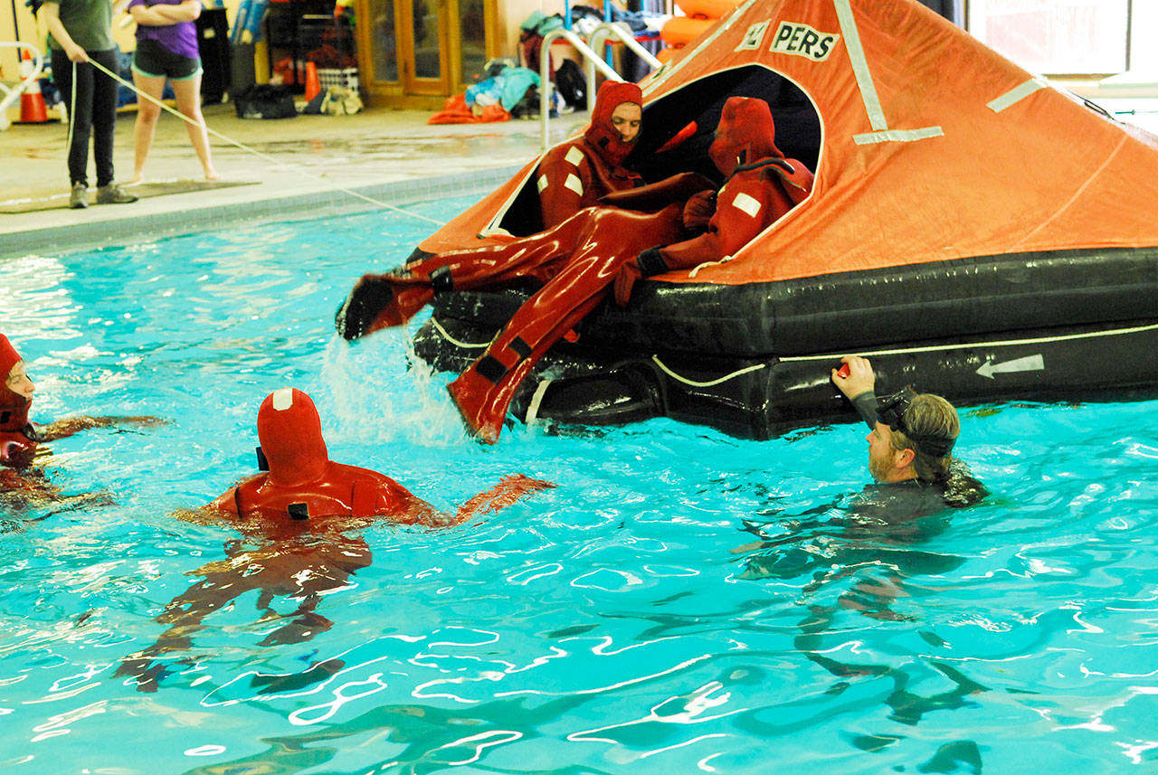 Part of the Northwest Maritime Center’s basic training class for new mariners is practicing to get into a life raft. Students practiced teamwork drills to ensure everyone was safely onboard the craft. (Jeannie McMacken/Peninsula Daily News)