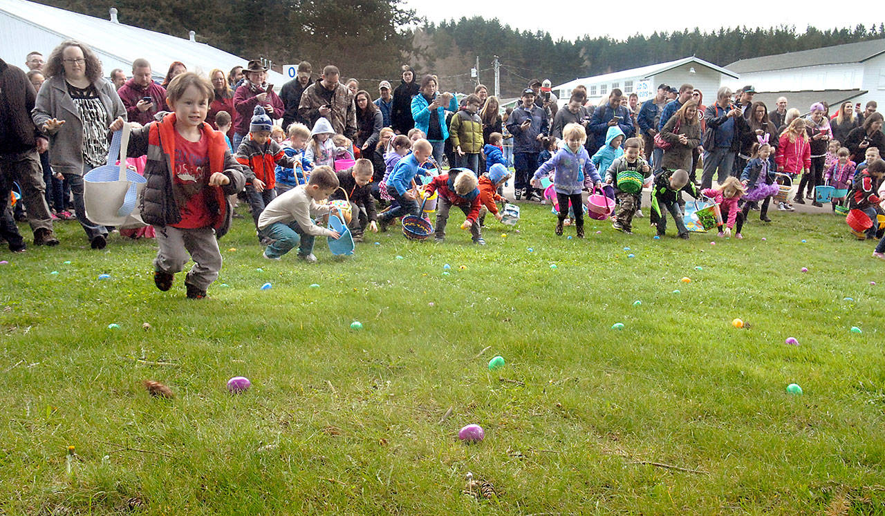 Youngsters race to collect eggs containing prizes during Saturday’s 40th annuyal KONP Easter Egg Hunt at the Clallam County Fairgrounds in Port Angeles. Besides thousands of eggs, registered children were eligable for drawings for additional prizes. (Keith Thorpe/Peninsula Daily News)