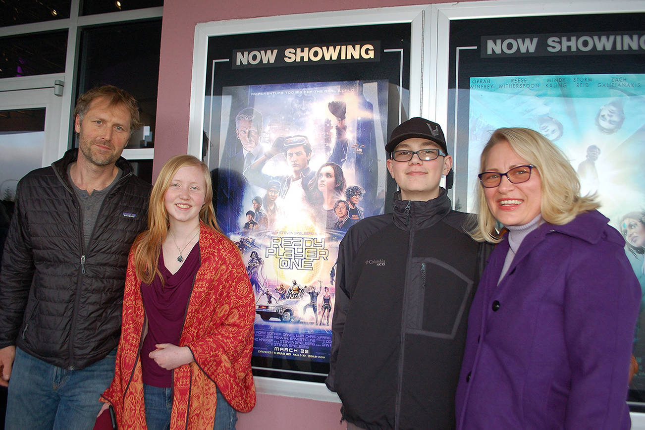 In honor of Robby Streett, his family and friends filled the theater at Deer Park Cinema on March 30 for a showing of his favorite book adapted into a film, “Ready Player One.” Josh Gloor, left, Robby’s girlfriend Hannah Gloor, brother Sawyer Streett and mother Josslyn Streett were among those who watched the film and celebrated his love for the book. (Erin Hawkins/Olympic Peninsula News Group)