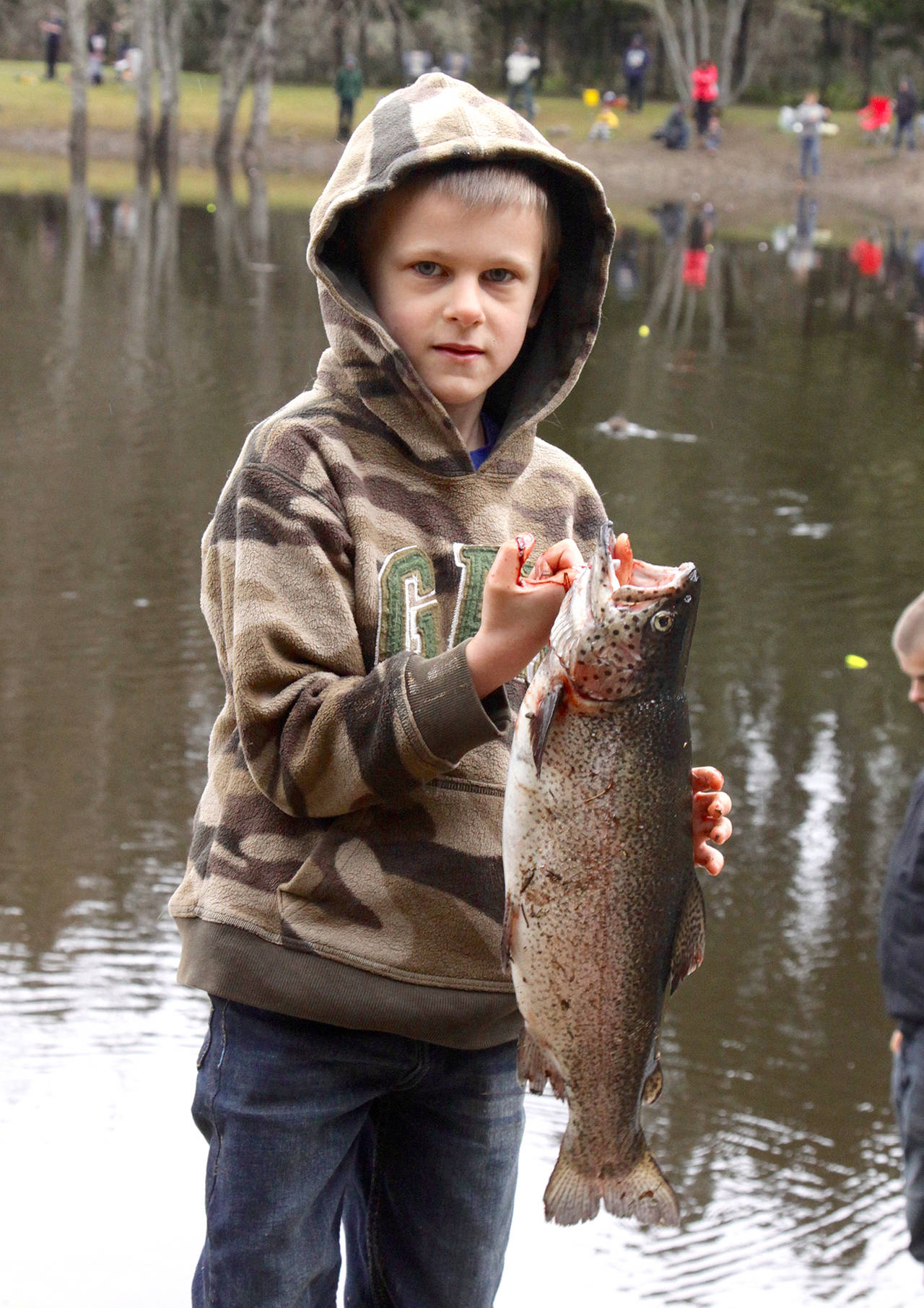 Nathanael Gump holds a 20-inch rainbow trout he caught during the 2017 Kid’s Fishing Derby at the Lincoln Park Ponds.                                Dave Logan/for Peninsula Daily News