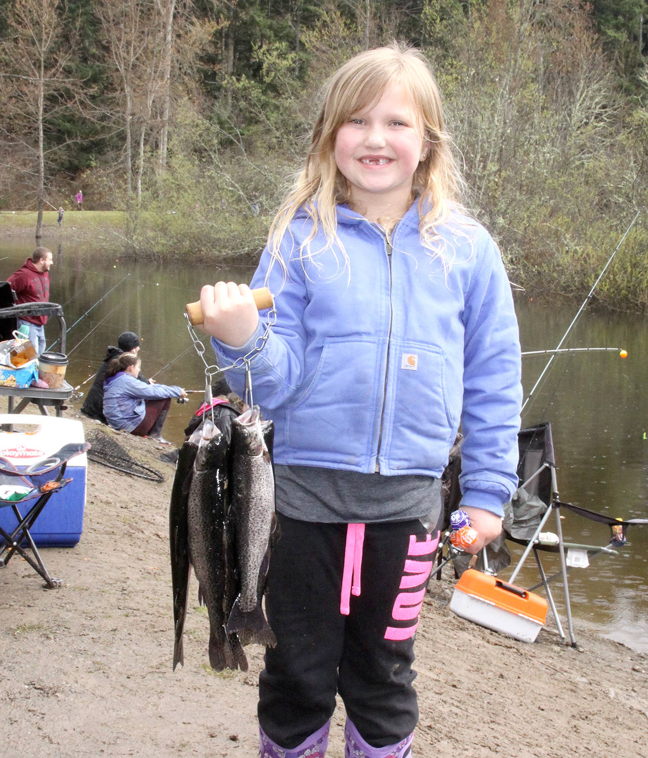 Dave Logan/for Peninsula Daily News                                Mackenzie Lobbe, age 6 of Port Angeles, holds five rainbow trout she and members of her family caught at the Port Angeles Kids Fishing Derby Saturday at Lincoln Park. Chloe Bitze, 8, caught the largest fish of the day, a 22-inch rainbow. The annual event was put on by Olympic Peninsula Fly Fishers, Port Angeles Kiwanis, the state Department of Fish and Wildlife and city of Port Angeles Parks and Recreation.