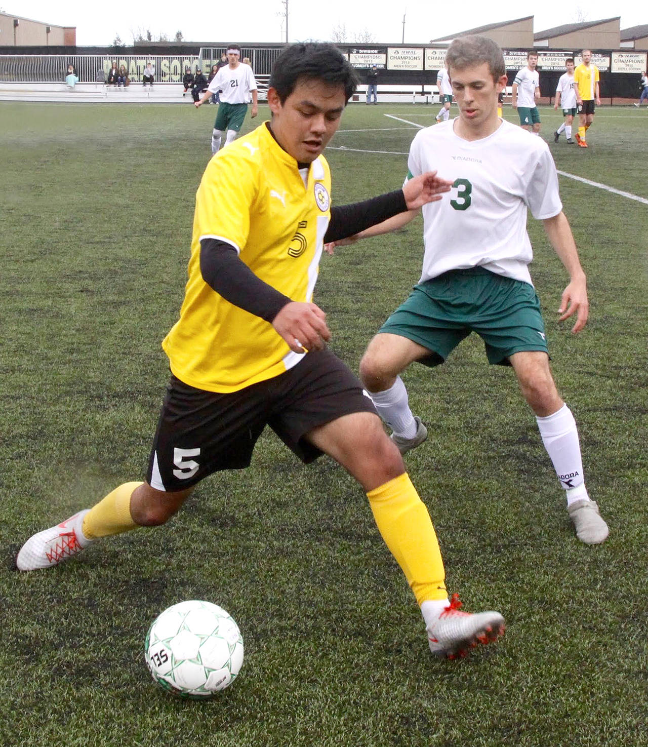 Sequim’s Rudy Franco, left, protects at the ball from Port Angeles’ Andrew St. George during a nonleague friendly match between the two rivals Saturday at Peninsula College.                                Dave Logan/for Peninsula Daily News