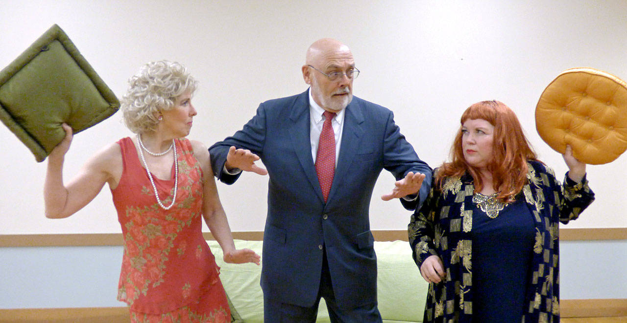 Becky Eastgard, left, and Vicki Valley fight over the presidential suite as hotel manager Gil Skinner tries to separate them in in the upcoming Ludlow Village Players production of “Suite Surrender.” (Ginny Ford/Ludlow Village Players)