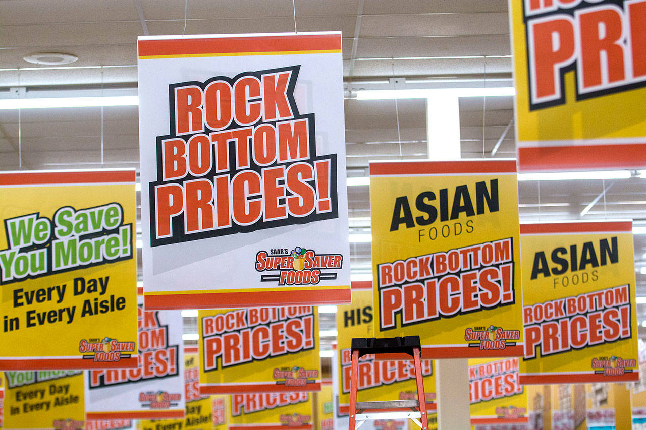 Signs advertising Super Saver Foods’ “rock bottom prices” hang in the soon-to-be Super Saver Foods in Port Angeles on Monday. (Jesse Major/Peninsula Daily News)