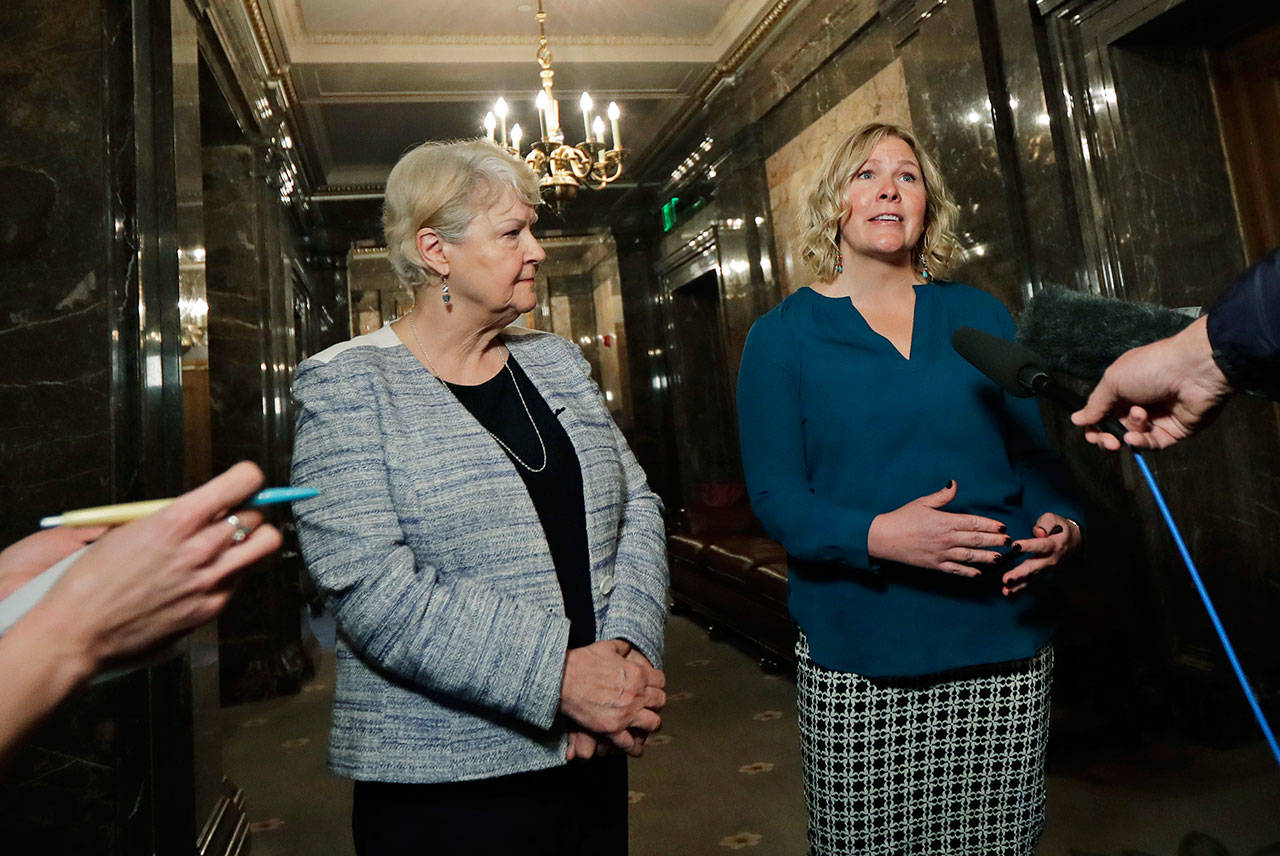 In this March 21, photo, Rebecca Johnson, right, a lobbyist who helped organize a letter signed by more than 200 women calling for a culture change at the state Capitol, talks to reporters as Sen. Karen Keiser, D-Des Moines, left, looks on in Olympia. (Ted S. Warren/The Associated Press)