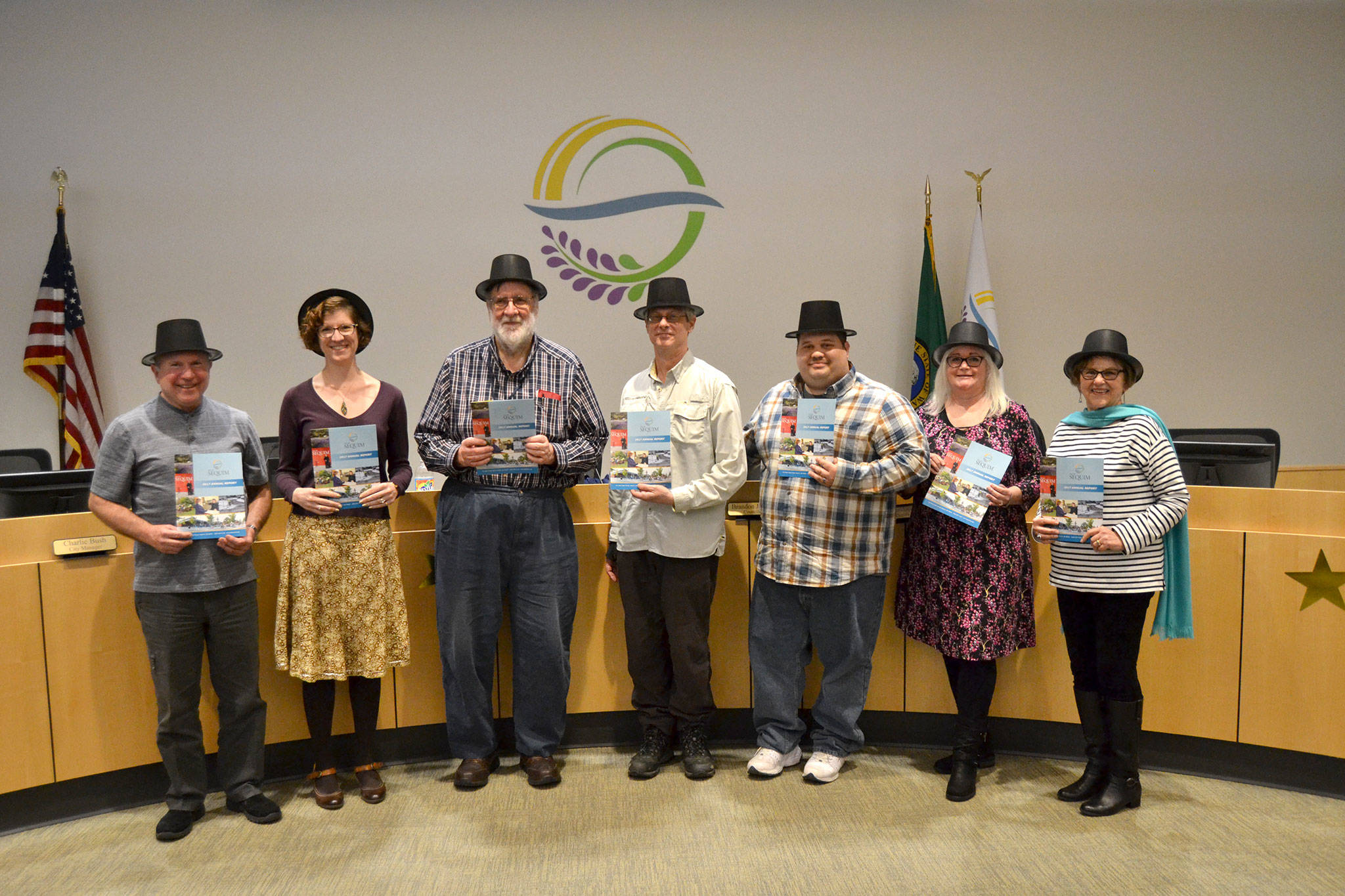 Sequim City Council members, from left, Mayor Dennis Smith, Jennifer States, Ted Miller, Bob Lake, Brandon Janisse, Pam Leonard-Ray, and Deputy Mayor Candace Pratt stand together after a presentation on the City of Sequim’s 2017 Annual Report. Matthew Nash/Olympic Peninsula News Group