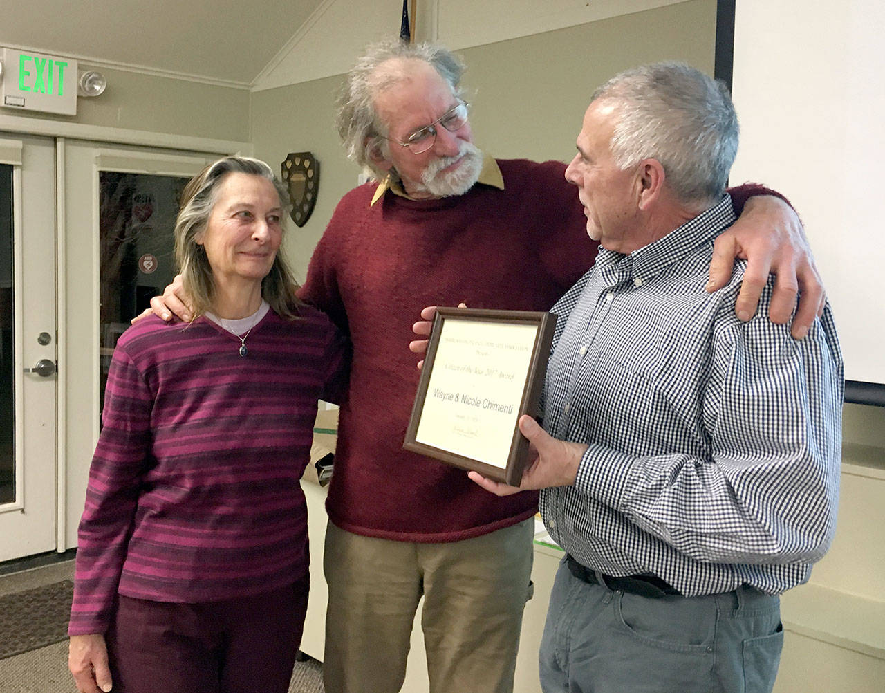 Marrowstone Island Citizens of the Year, from left, Nicole and Wayne Chimenti, are shown with former Citizen of the Year Mike Zimmerman.