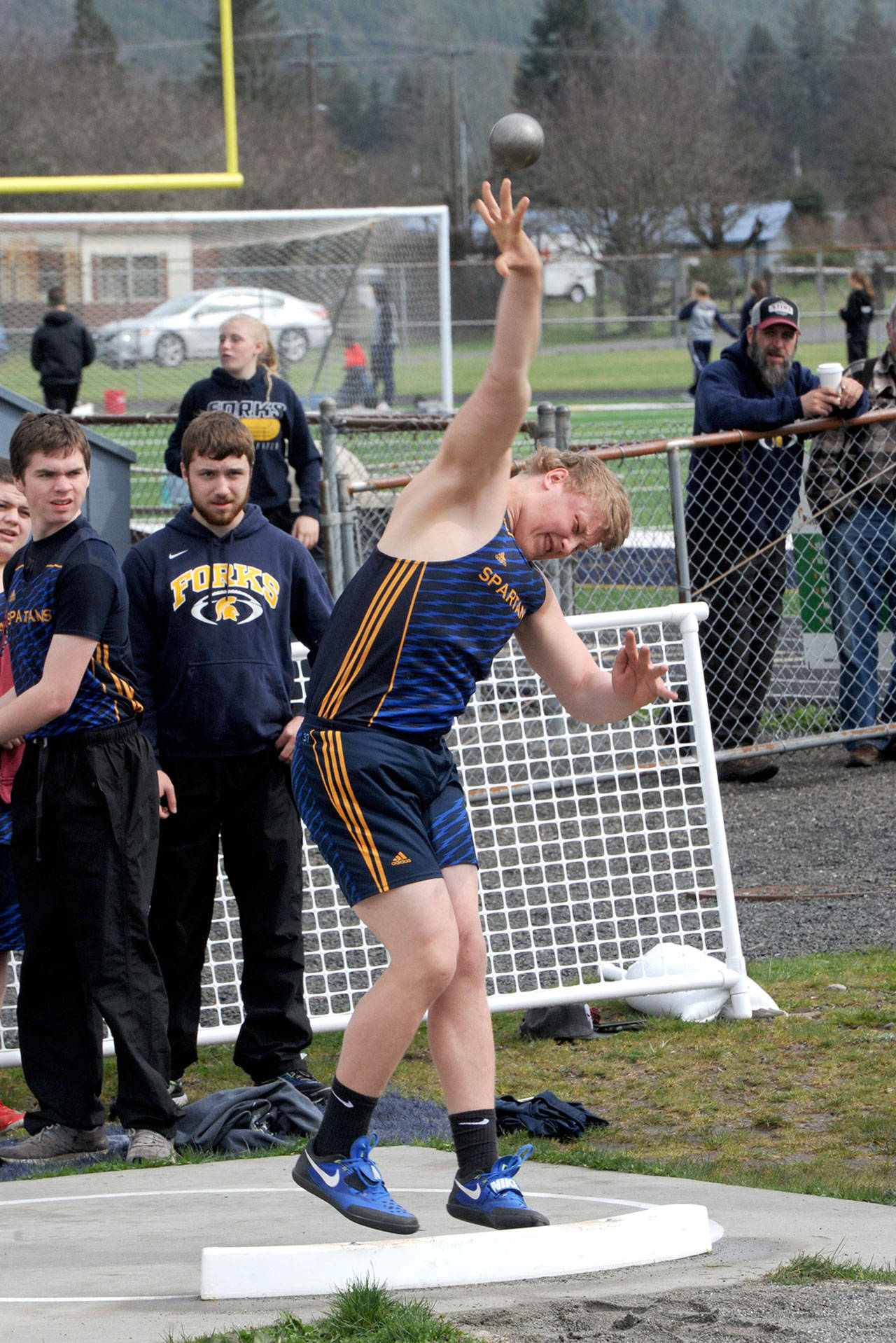 Forks’ Luke Dahlgren competes in the shot put at the Forks Lions Club Invitational in Forks on Saturday. Dahlgren won the event with a distance of 39 feet, 5 1/2 inches. (Lonnie Archibald/for Peninsula Daily News)