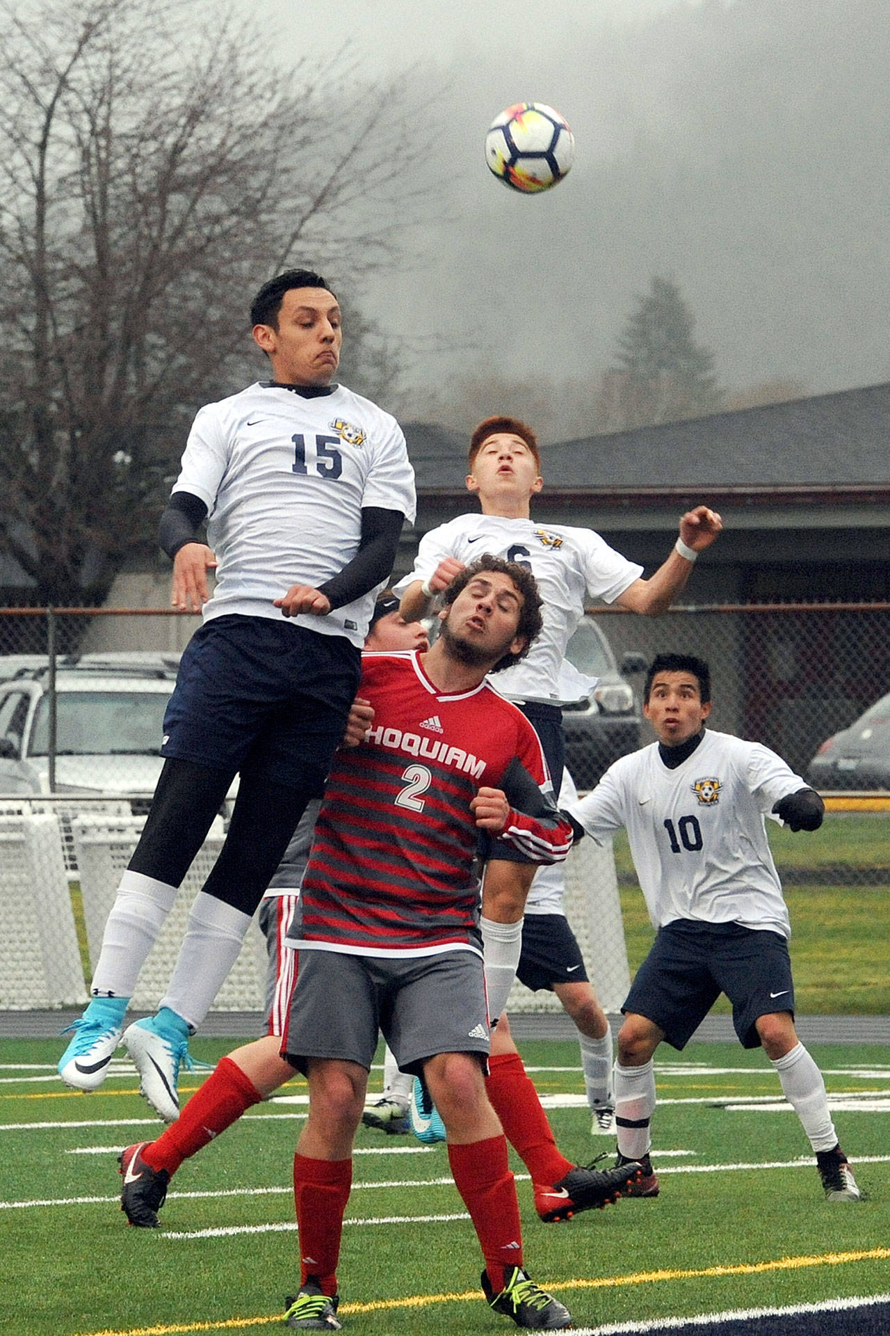 Forks Aristeo Weed (15), Oscar Gonzalez (6), and Samuel Gomez (10) compete with Hoquiams James Courneya (2) in front of the net during the Spartans 4-2 win over the Grizzlies on Monday night at Spartan Stadium. (Lonnie Archibald/for Peninsula Daily News)