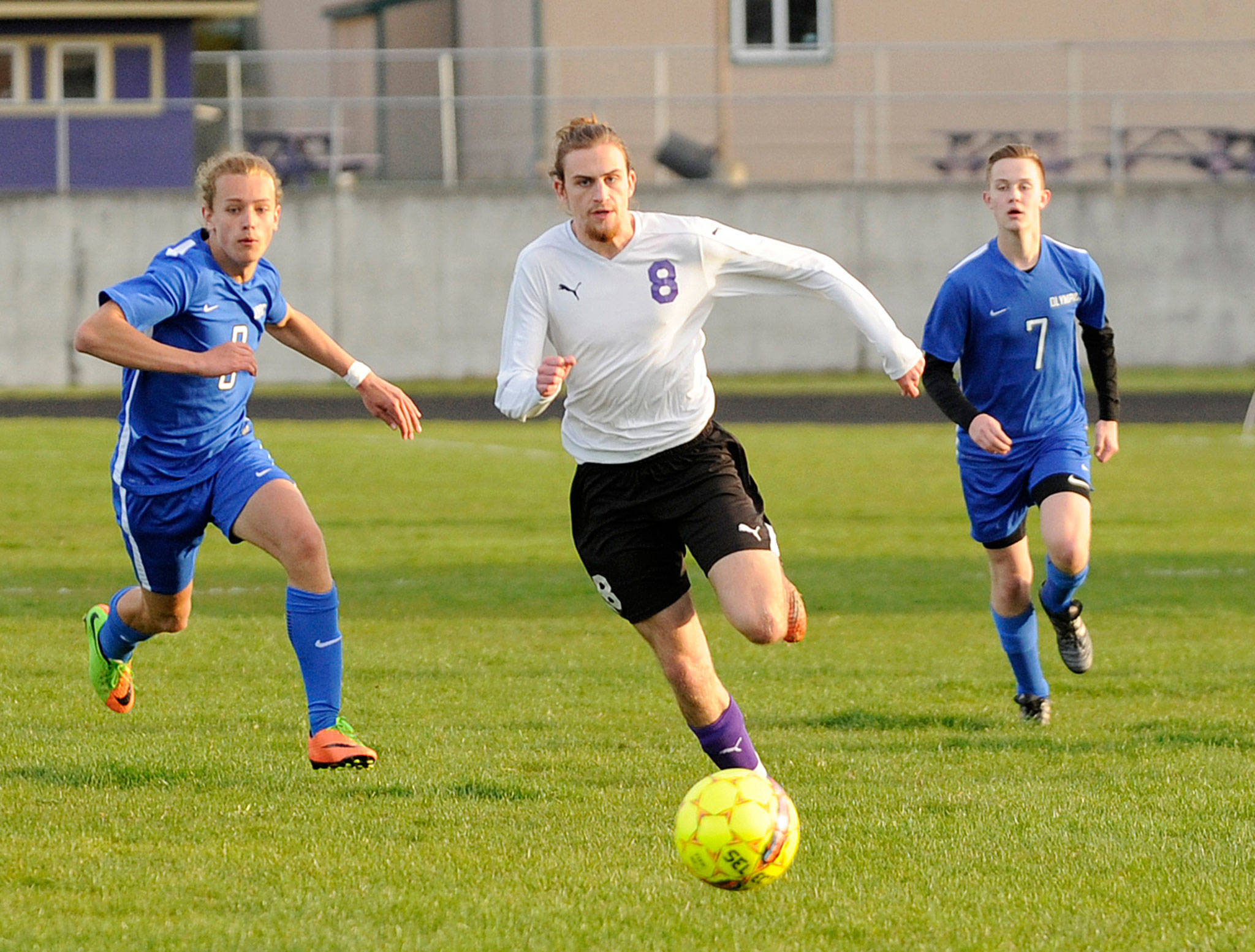 Michael Dashiell/Olympic Peninsula News Group Sequim’s Liam Harris, chasing down the ball earlier this season against Olympic, tied Kai Antrim’s school record for career goals (40) with a score Tuesday against North Mason.