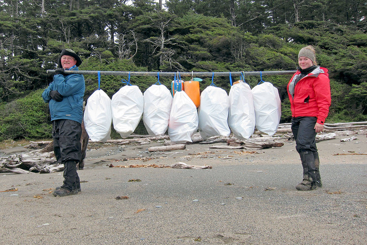 Kelsie Donleycott, the 2017 CoastSaver of the Year, is pictured at right with an unidentified friend cleaning up the coast near Ozette last year.