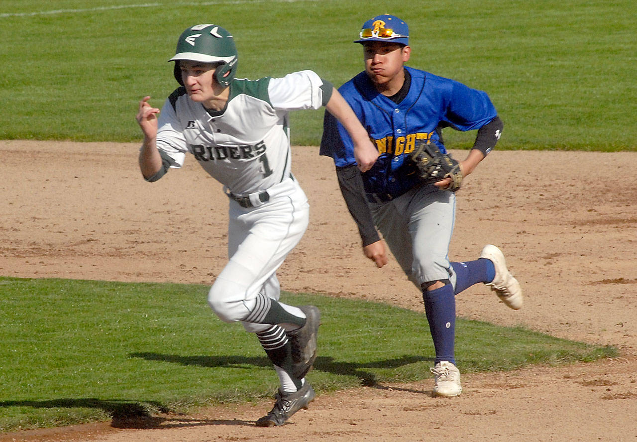Port Angeles’ Daniel Basden tries to outrun Bremerton shortstop Hector Infante after being caught between bases during the first inning on Wednesday at Port Angeles Civic Field.                                Keith Thorpe/Peninsula Daily News