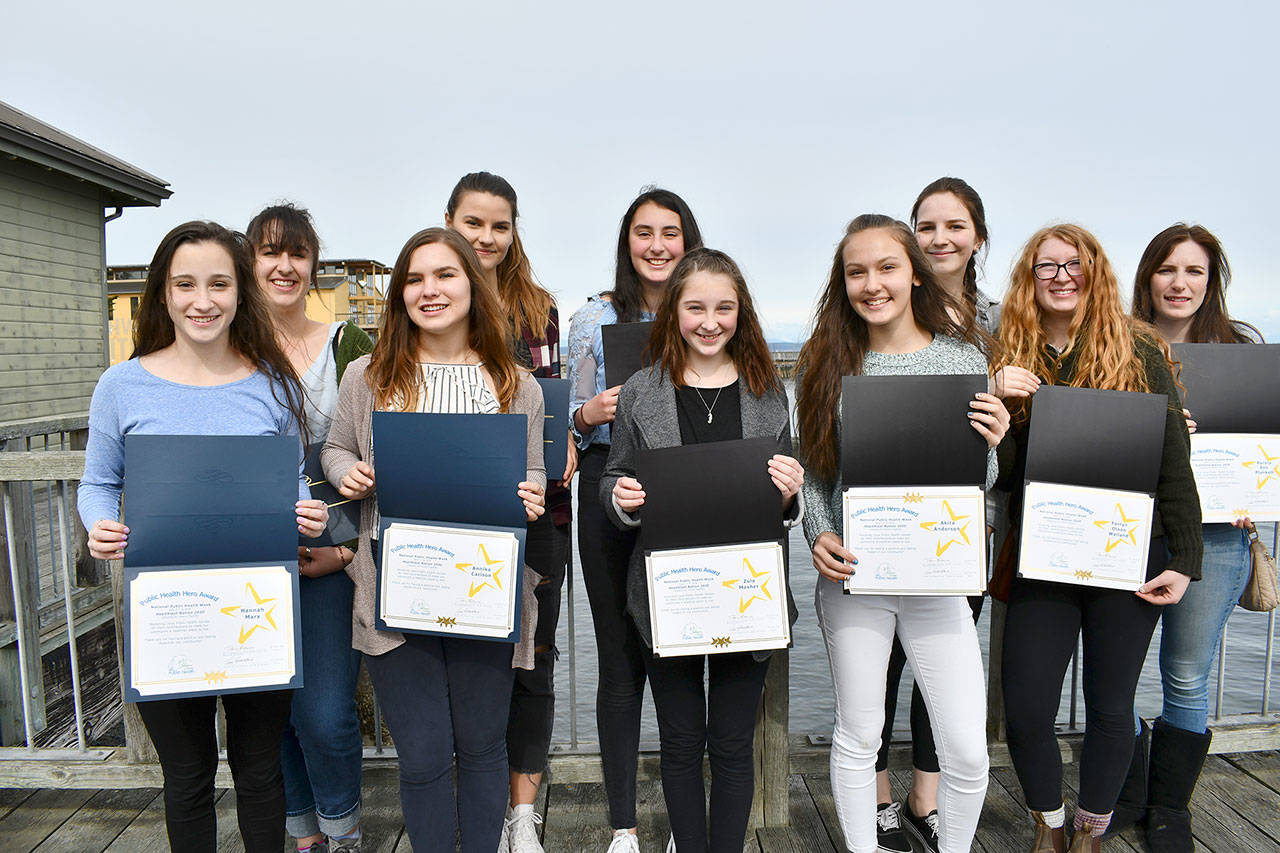 The Jefferson County Board of Health honored students from Port Townsend and Chimacum High School as “Health Heroes” for their roles in the “Enough is Enough” school walkout last month. The Public Health Leadership honorees include, back row from left, Mimi Molotsky, Ingrid Schultz, Ava Vaugh, Clara Noble and Aurora Plunkett; and front row, Hannah Marx, Annika Carlson, Zula Mosher, Akira Anderson and Farryn Wailand. Not present were Lilly Carillo, Ollie Crecca and Caitlyn Boyd. (Jeannie McMacken/Peninsula Daily News)