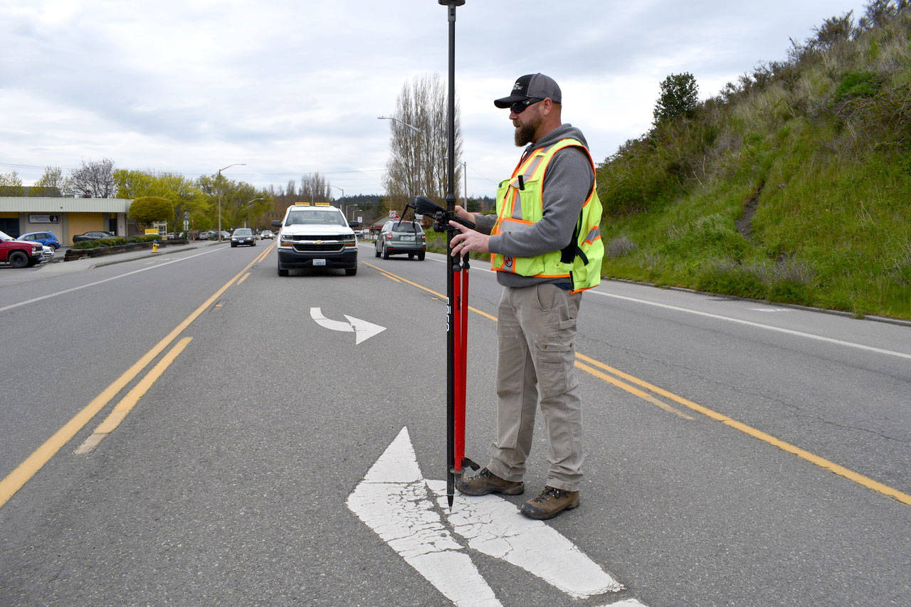 Blaine Schiess, survey party chief for the state Department of Transportation, takes some engineering measurements in advance of the paving and construction project on Highway 20 that will begin Monday. (Jeannie McMacken/ Peninsula Daily News)