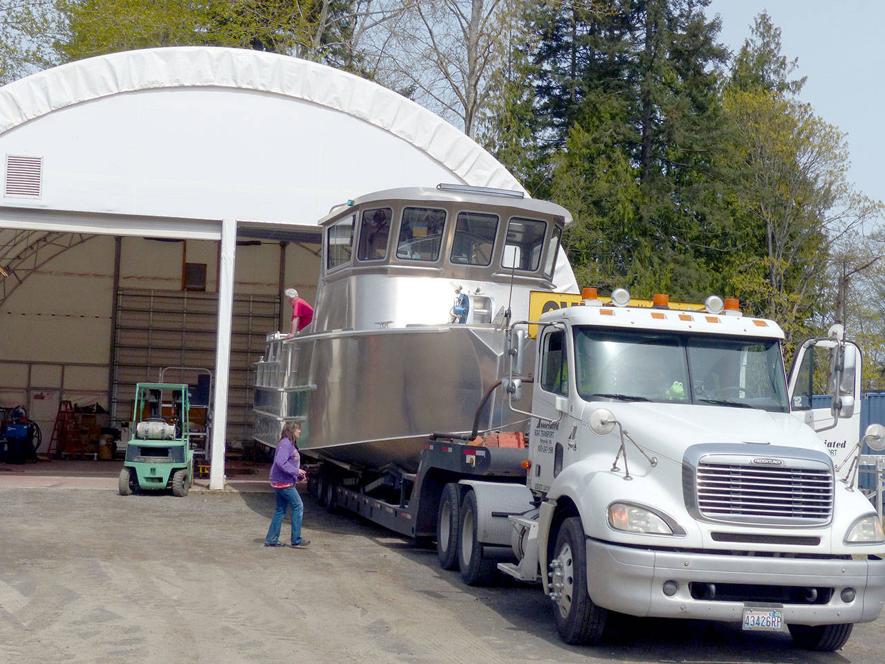 A Bristol Bay boat is loaded on a lowboy trailer for transport to the Port Angeles Boat Yard to be launched. (David G. Sellars/for Peninsula Daily News)