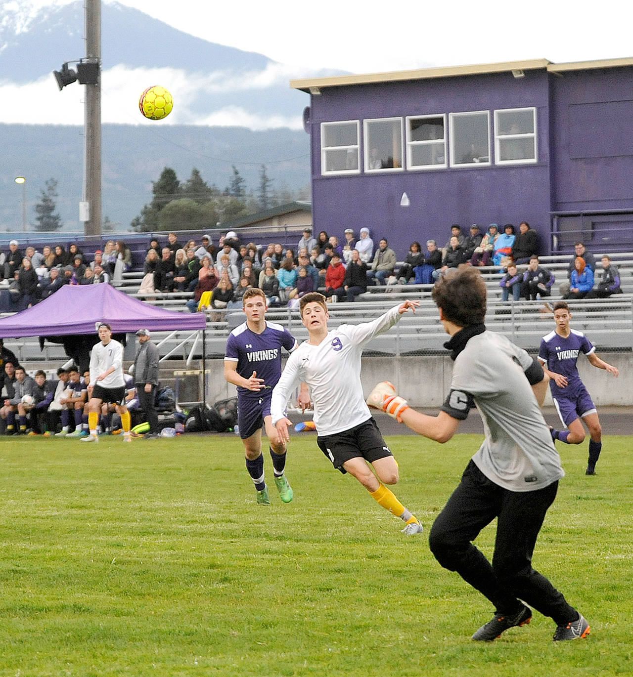 Michael Dashiell/Olympic Peninsula News Group Sequim’s Adrian Funston tries to track down the ball deep in North Kitsap territory as Viking goalkeeper Matthew Tucker makes a play. Funston had two goals in the Wolves’ 5-0 win Friday night