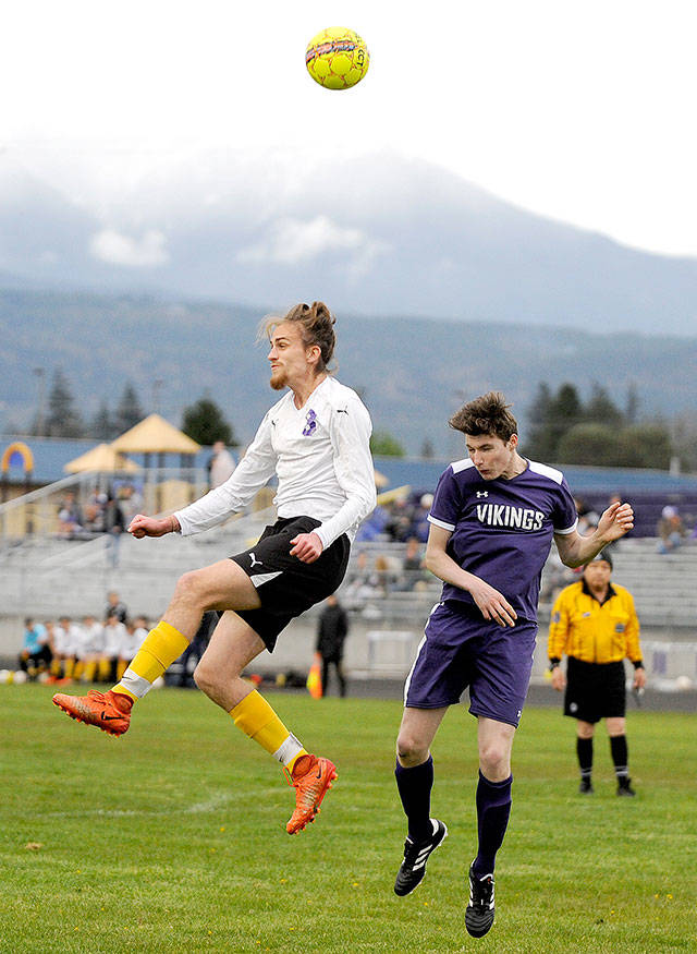 Sequim’s Liam Harris, left, goes up for a header in the first half of the Wolves’ 5-0 win over North Kitsap on Friday. Michael Dashiell/North Olympic News Group