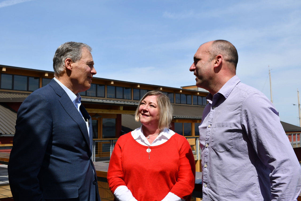 Gov. Jay Inslee meets with Tanya Rublaitus and Jake Beattie of the Northwest Maritime Center after the Results Washington review held in Port Townsend on Tuesday. (Jeannie McMacken/Peninsula Daily News)