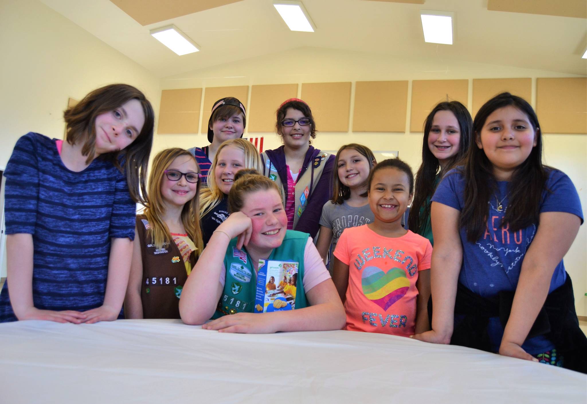 Girl Scouts with Troop 45181 gather around Paige Krzyworz, 11, front center, to celebrate her accomplishment of selling the most boxes of Girl Scout cookies in Western Washington. (Matthew Nash/Olympic Peninsula News Group)