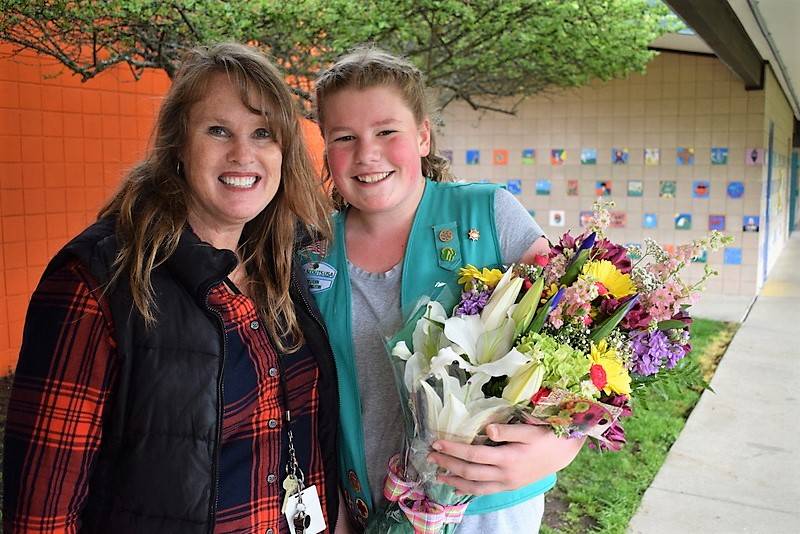 Last Friday, Paige Krzyworz was surprised by her mom Heidi and fifth-grade teacher Gail Kite, pictured, to learn she sold the most Girl Scout cookies in Western Washington. Girl Scouts of Western Washington sent a bouquet to Helen Haller Elementary to celebrate. (Heidi Krzyworz)