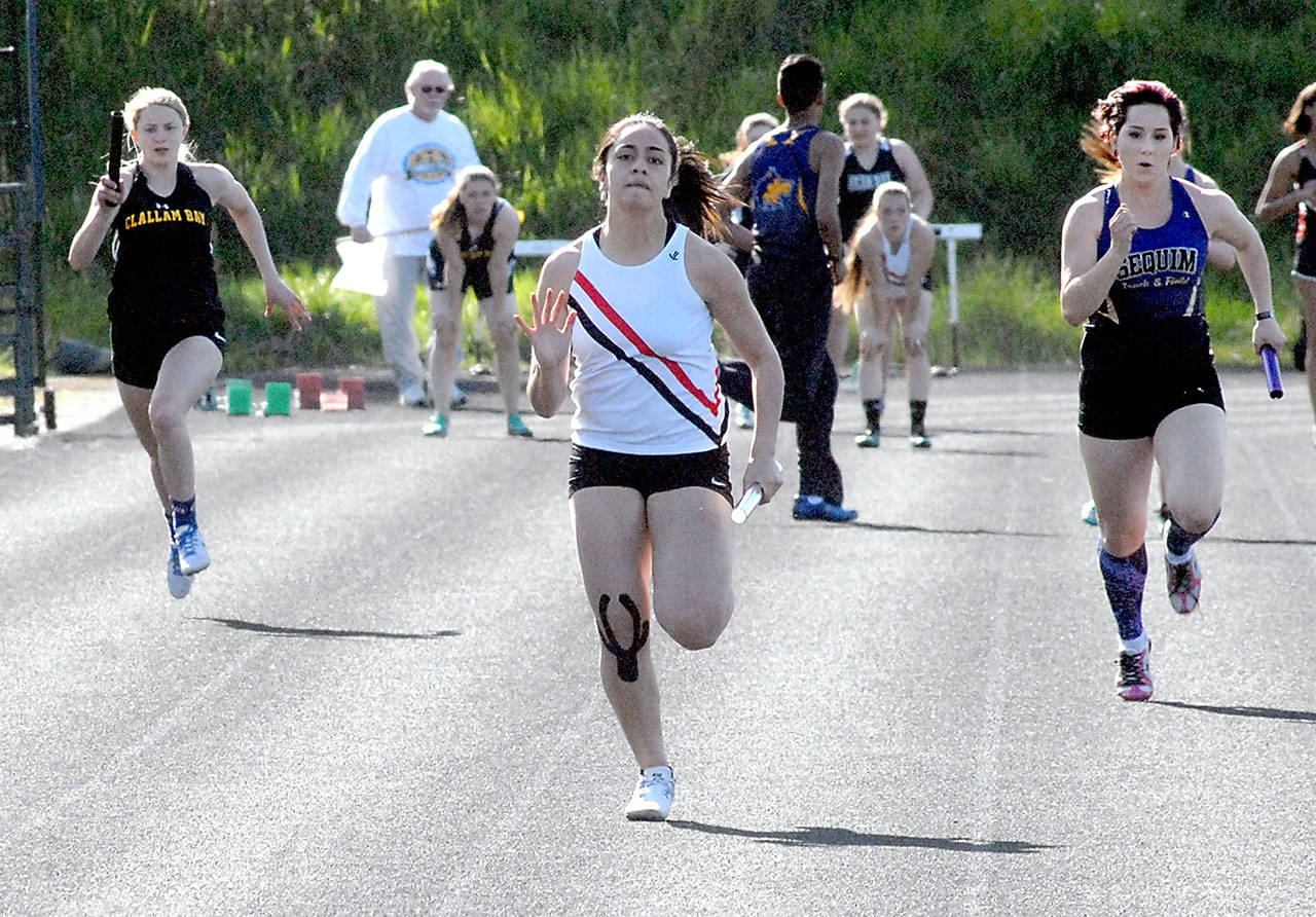 Keith Thorpe/Peninsula Daily News Port Townsend anchor Eileen Leoso, center, sprints to the finish to win the girls 4x100 meter relay for her team during Fridays meet at Port Angeles High School. Trailing behind were Miriam Wonderly of Clallam Bay, left, and Telicia Busby of Sequim, right.
