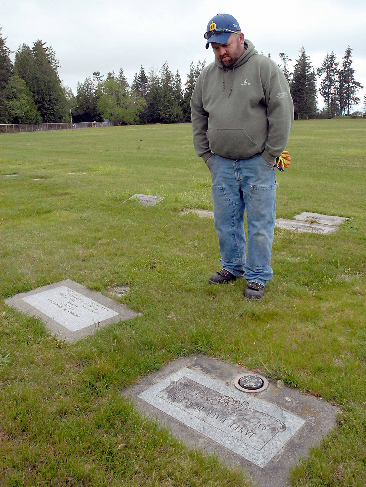 Jimmy Bowcutt stands on Friday at the Port Angeles grave site of his mother, who was murdered 40 years ago last week. (Keith Thorpe/Peninsula Daily News)