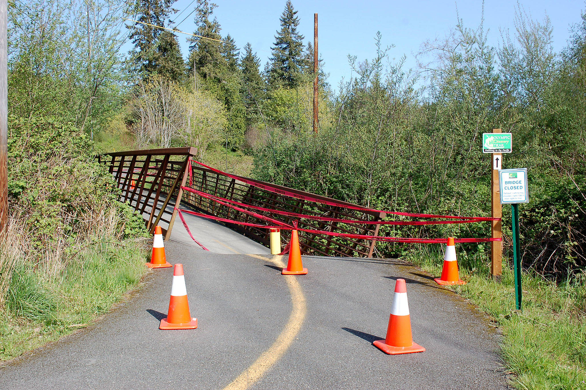 In mid-April, a portion of the Dean Creek bridge in Blyn sunk due to high water leading officials with the Jamestown S’Klallam Tribe and the Peninsula Trails Coalition to close it. No timetable has been set for its repair. (Erin Hawkins/Olympic Peninsula News Group)