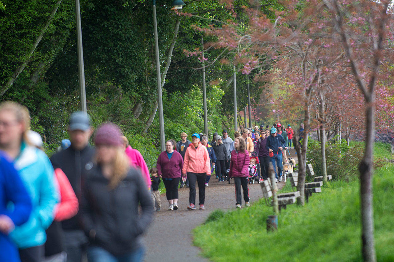 A group of mostly women walk the Olympic Discovery Trail during the Run Without Fear on Sunday. (Jesse Major/Peninsula Daily News)