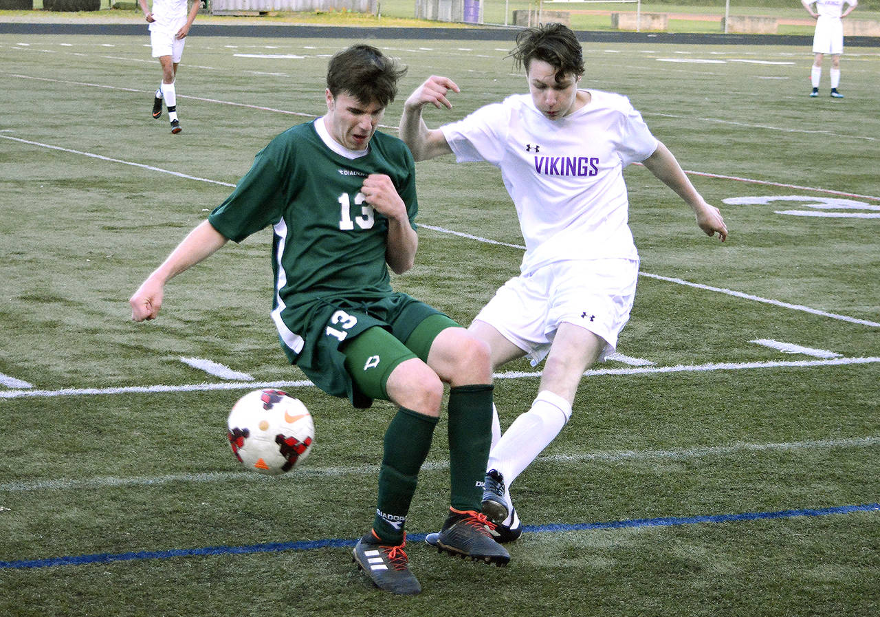 Mark Krulish/Kitsap News Group Port Angeles Stuart Methner, left, tries to knock away a pass by North Kitsaps Clayton Bond in the Riders 3-0 loss to the Vikings.