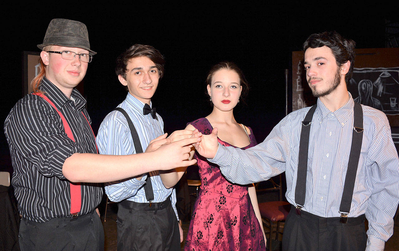 Practicing a “mock toasting” during rehearsal are, from left, Sage Star, Simon Close, Sammy Weinert and Brad Alemao. (Patsene Dashiell/Port Angeles School District)