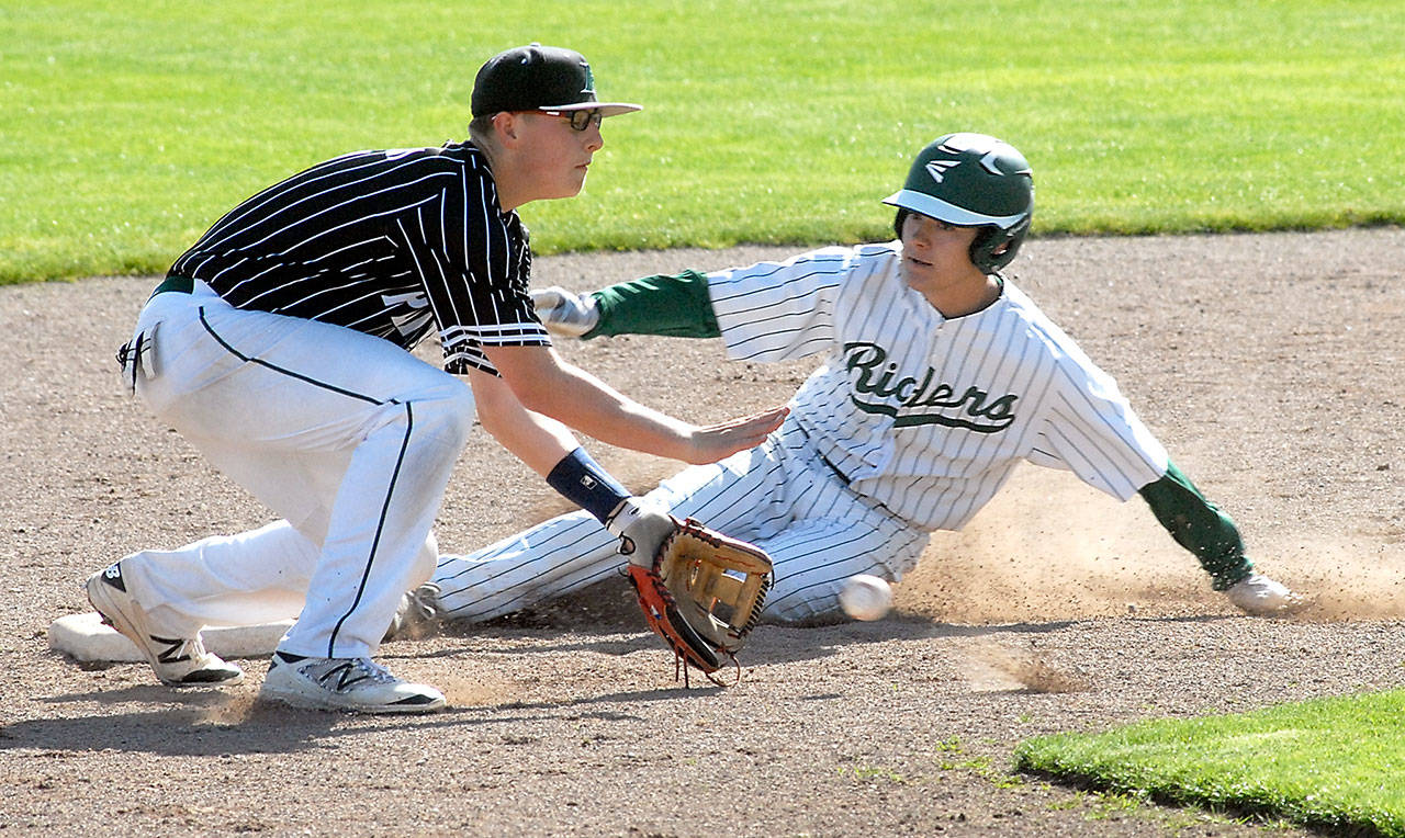 Keith Thorpe/Peninsula Daily News Port Angeles’ Tyler Bowen, right, successfully slides into second ahead of the throw to Peninsula’s Trent Buchanan in the second inning on Wednesday at Port Angeles Civic Field.