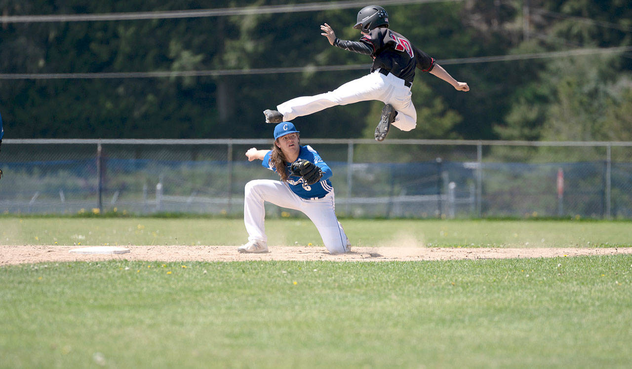 Chimacum’s Cole Dotson tags out Seattle Christian’s Colin Heffernan as he tries to leap to second base during a playoff game in Chimacum on Saturday. The Cowboys won 2-1. (Steve Mullensky/for Peninsula Daily News)