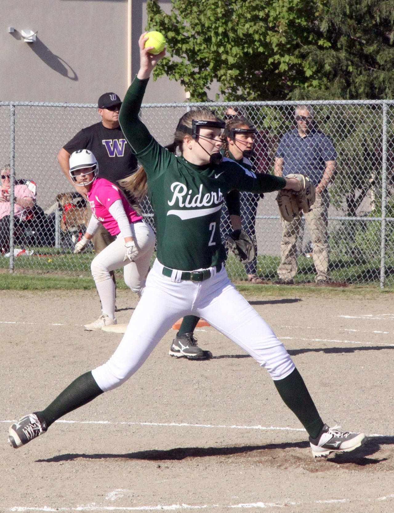 Port Angeles pitcher Callie Hall throws apitch to the plate while first baseman Erin Edwards waits. Also on first is Sequim baserunner Isabelle Dennis. Sequim beat Port Angeles 6-5 to snap a 10-game losing streak to the Roughriders. (Dave Logan/for Peninsula Daily News)