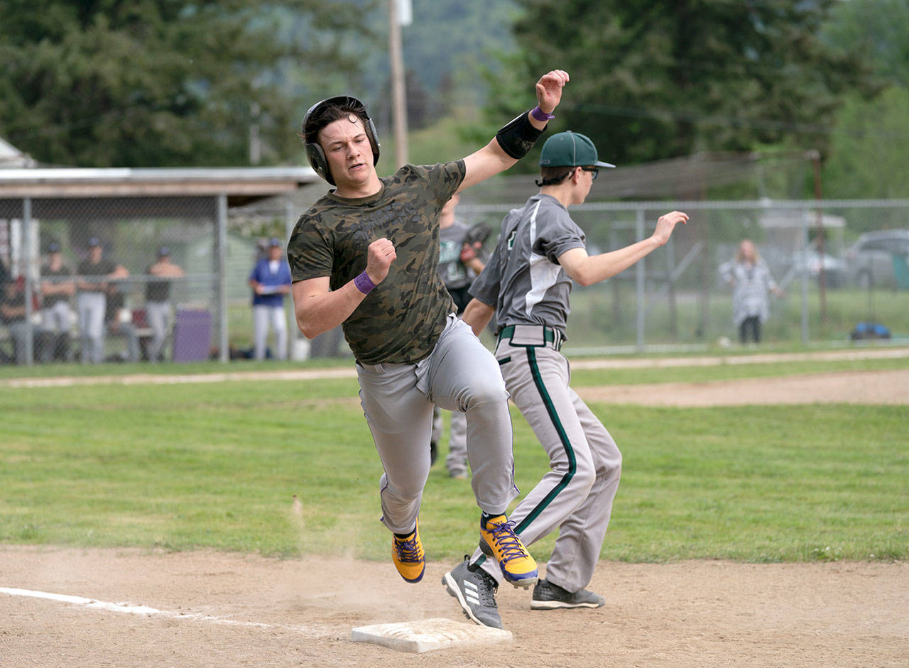 Steve Mullensky/for Peninsula Daily News Quilcenes Olin Reynolds bounces over first base after hitting a single in a loser-out game against the Mount Rainier Lutheran Hawks on Tuesday in Quilcene.