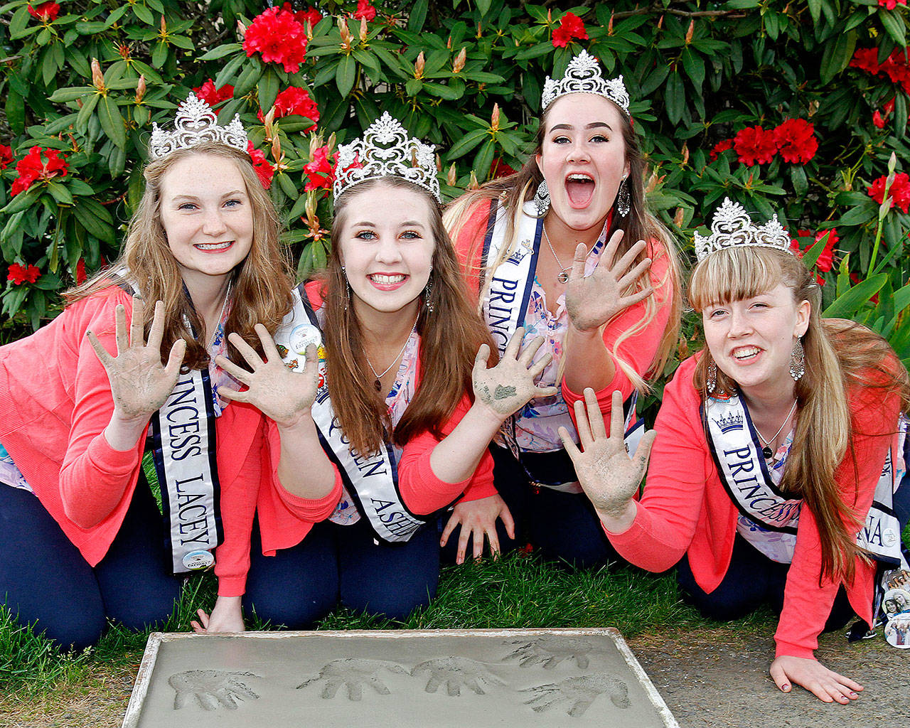 2018 Rhododendron Festival Royalty, from left, Princess Lacey Bishop, Queen Ashley Rosser, Princess Desirae Kudronowicz and Princess Skyanna Iardella press their hand into cement Tuesday.