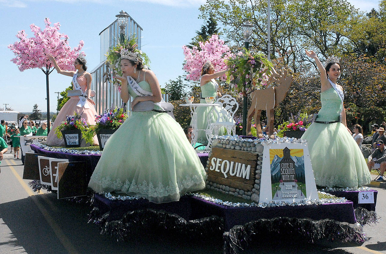 The Sequim Irrigation Festival’s namesake float with Irrigation royalty, from left, Queen Erin Gordon and princesses Gabi Simonson, Gracelyn Hurdlow and Lily Williams, rolls down Washington Street during Saturday’s Grand Parade. (Keith Thorpe/Peninsula Daily News)
