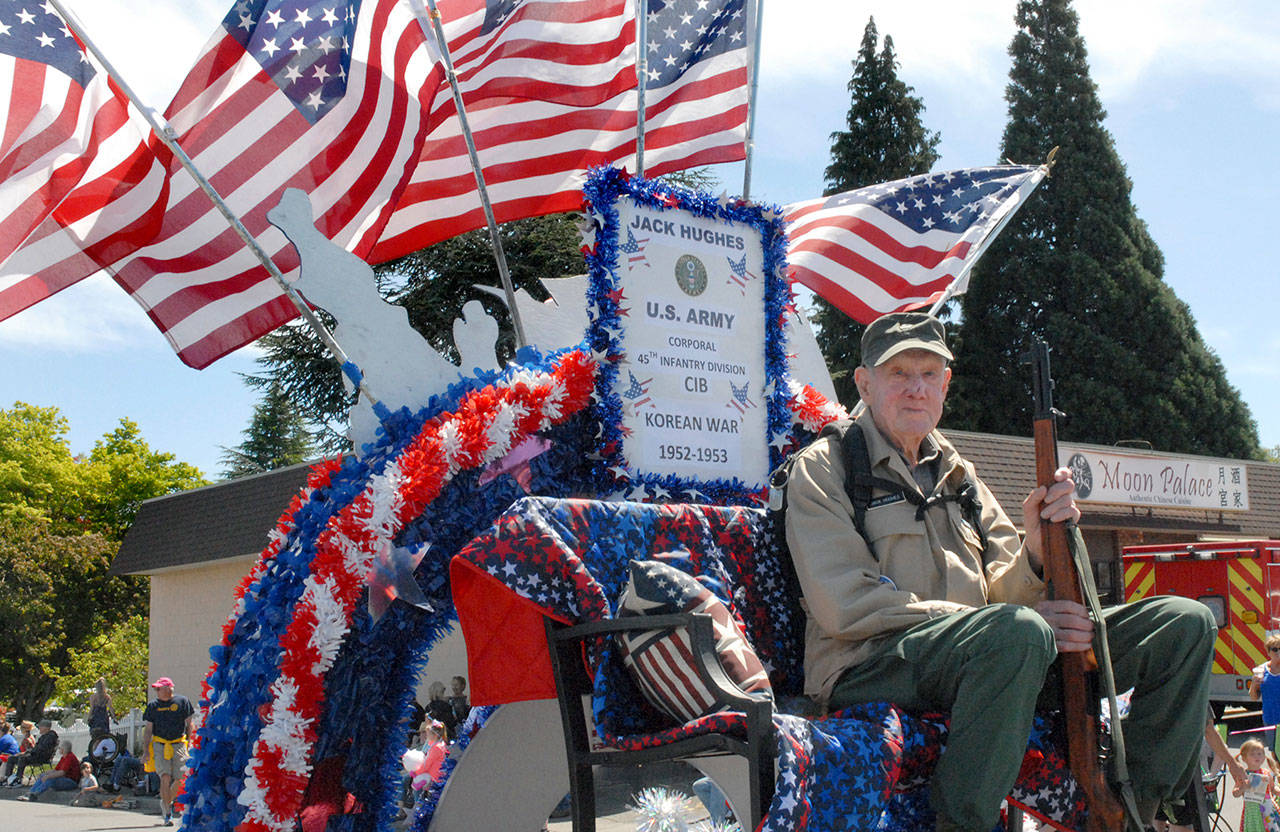 U.S. Army Korean War veteran Jack Hughes of Port Angeles, a long-time ranger for Olympic National Park, rides as guest of honor on the Forks Old Fashioned Fourth float on Saturday. (Keith Thorpe/Peninsula Daily News)