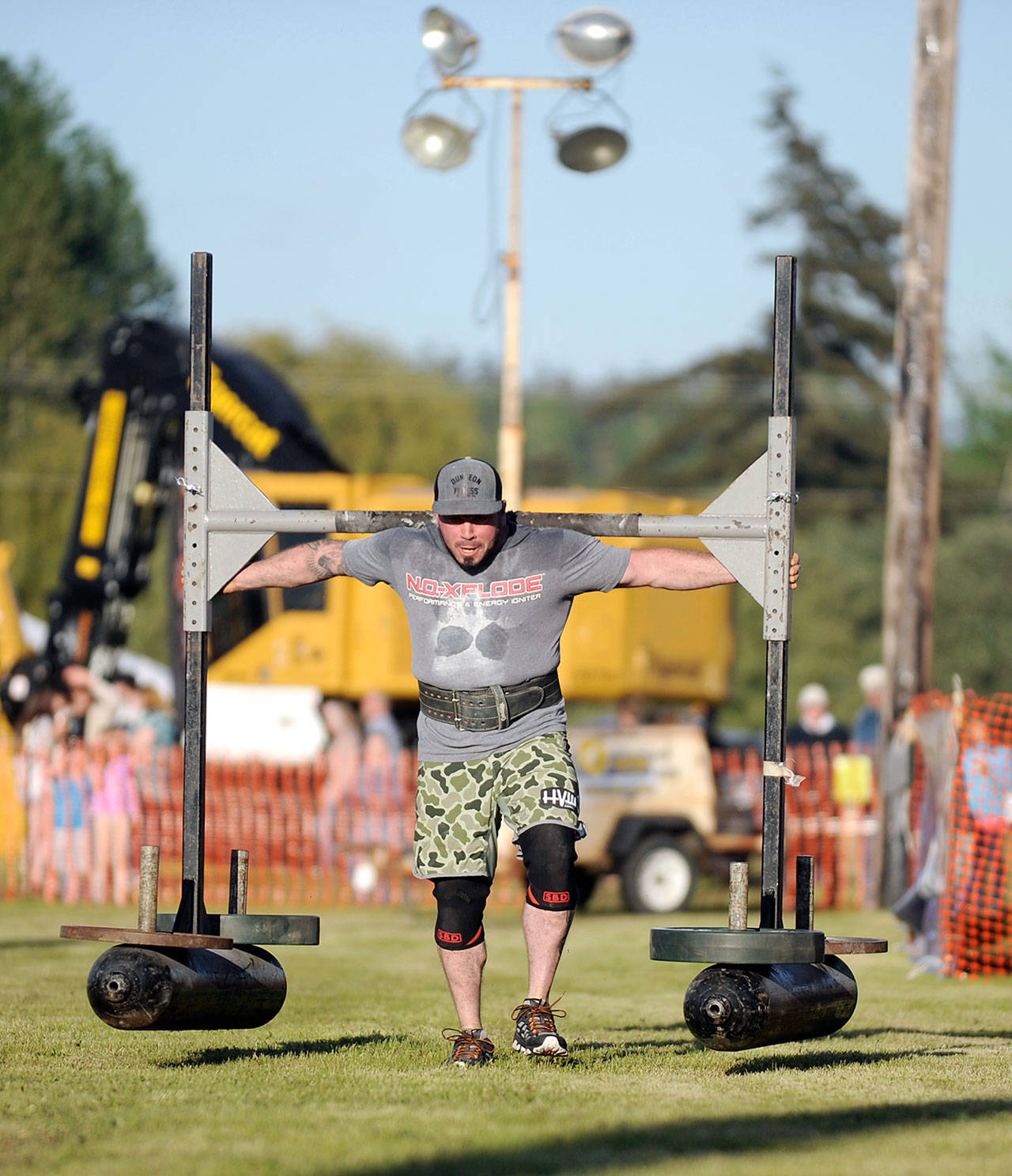 Nate Bolling of Sequim competes in the yoke walk portion of the Sequim Irrigation Festival Strongman Competition, held Saturday Night on the grounds of the 30th-annual Logging Show. (Michael Dashiell/Olympic Peninsula News Group)