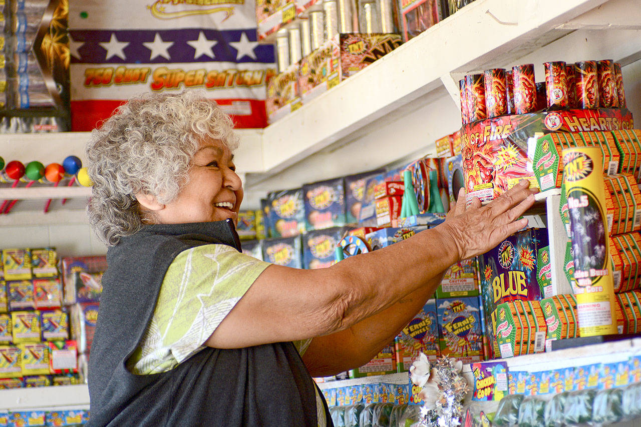 Margie Macias arranges fireworks at her fireworks stand, Margie Fireworks, on the Lower Elwha Klallam Tribe reservation in 2017. (Jesse Major/Peninsula Daily News)