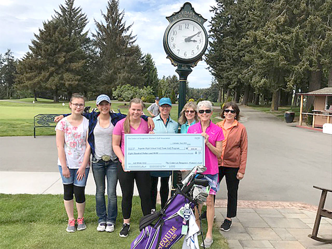 The Cedars at Dungeness Women’s Golf Club donated proceeds from its annual Whine & Roses Invitational Golf Tournament to the Sequim High School Golf program. Cathy Grant, Whine & Roses co-chair is joined by Judy Reno, co-captain, Lisa Ballantyne, captain, and Jan Clendening in presenting the check to Sarah Shea, captain of the girls golf team. Shea is joined by Sequim teammates Minzie Koch and Yana Hoesel.                                The Cedars at Dungeness Women’s Golf Club