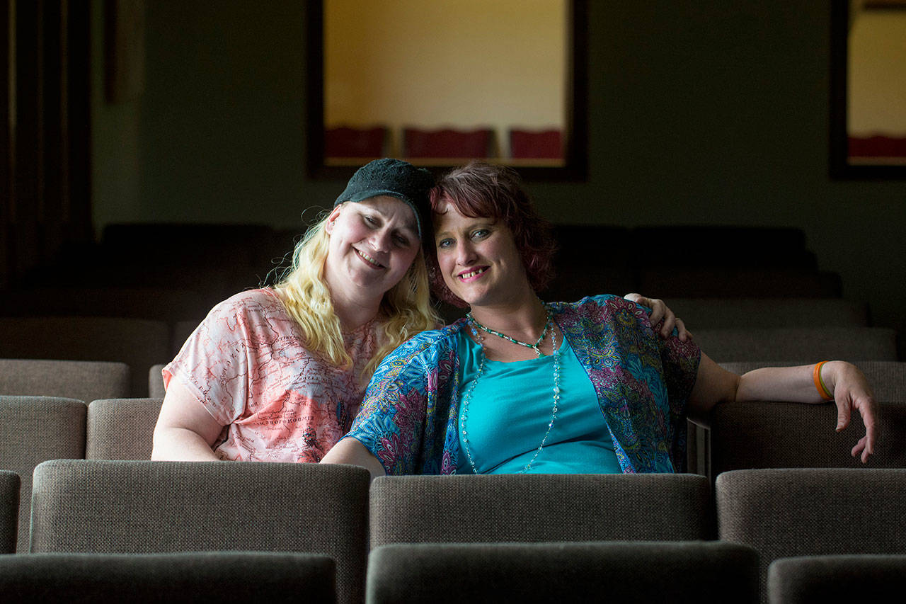 Tami Frederick, left, sits with her sister Jenni Tiderman after attending Revolution Church in Port Angeles together on May 6. The two credit the support they recieve at Revolution Church for helping them in their recovery from drug addiction. (Jesse Major/Peninsula Daily News)