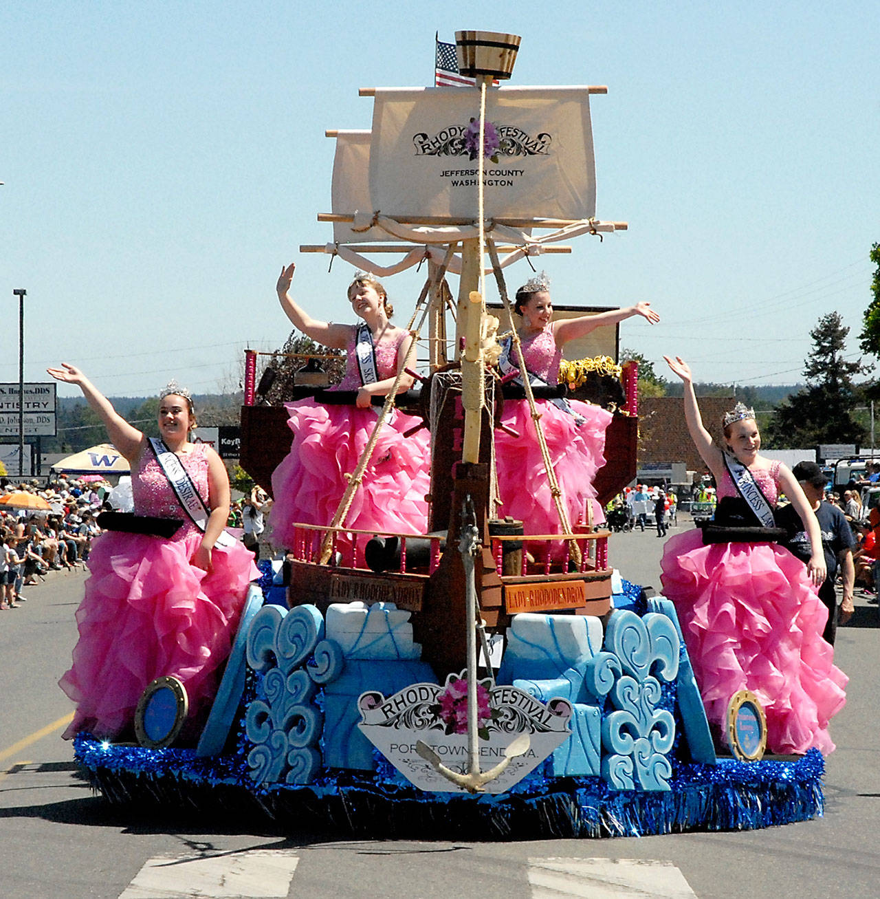 The Port Townsend Rhody Festival float with royalty, from left, princesses Desirae Kudronowicz and Skyanna Iardella, Queen Ashley Rosser and Princess Lacey Bishop takes part in the Irrigation Festival Grand Parade in Sequim. (Keith Thorpe/Peninsula Daily News)