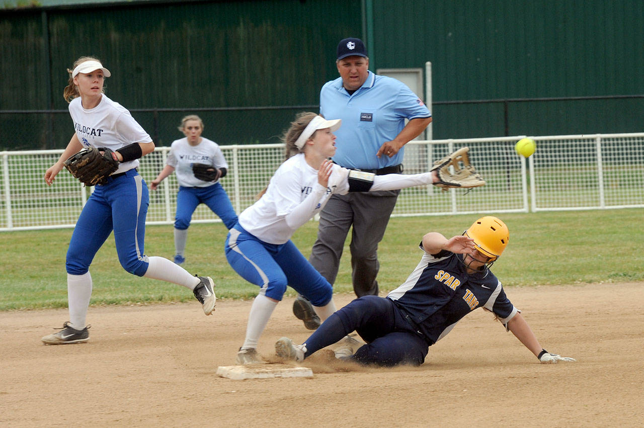 Lonnie Archibald/for Peninsula Daily News Forks’ Rian Peters steals second base while La Center’s Ceanna Johnson awaits the throw during district softball action at Borst Park in Centralia.
