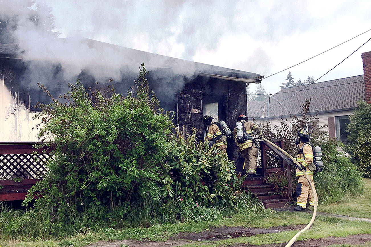 East Jefferson Fire Rescue firefighters attack a blaze that burned a home in Port Ludlow.