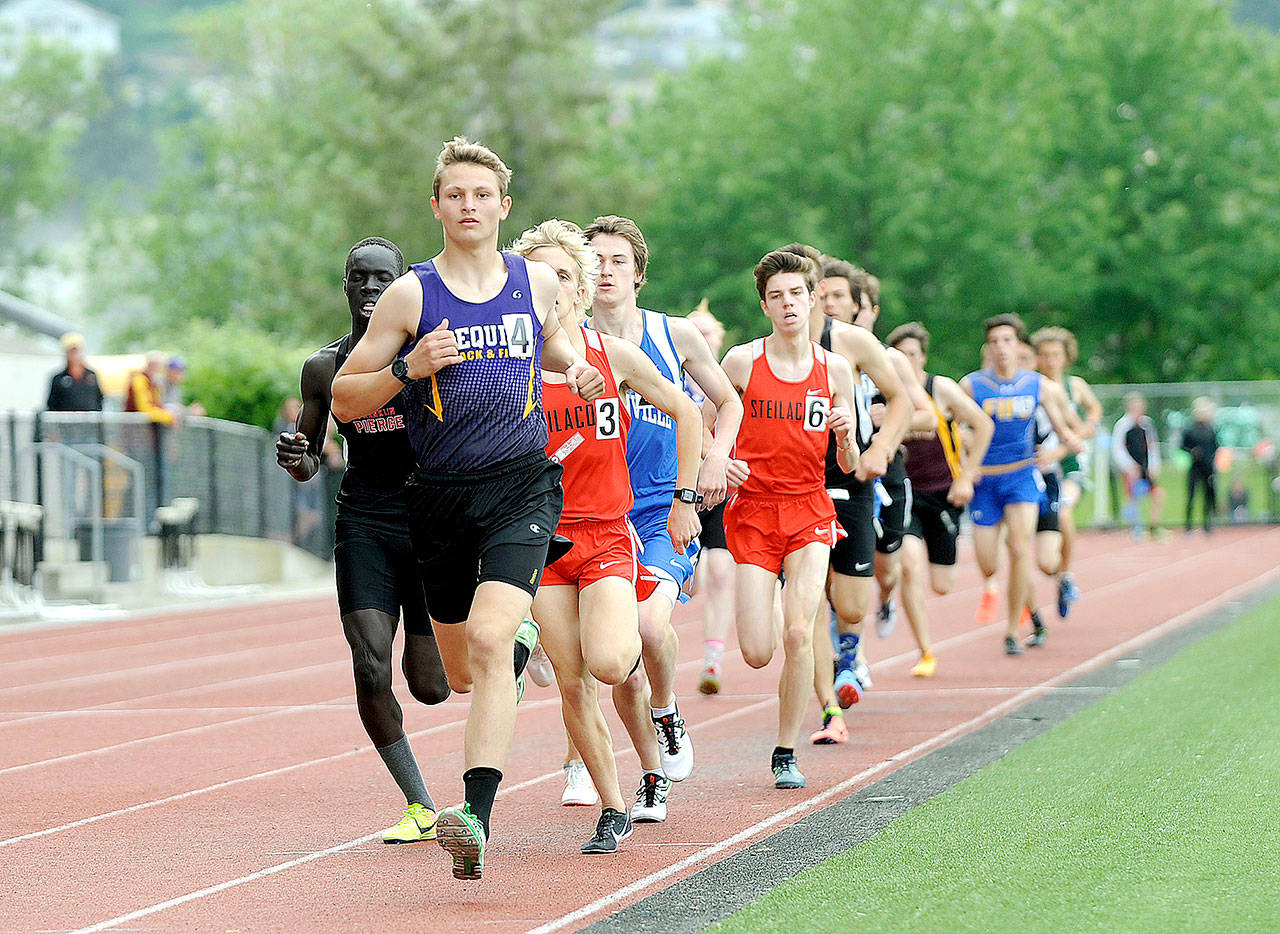 Murray Bingham leads the field in the 1,600-meter race at the West Central District III championships Saturday. Bingham won the race as well as the 3,200 and helped the Sequim relay team win the 4x400. (By Michael Dashiell/Olympic Peninsula News Group)