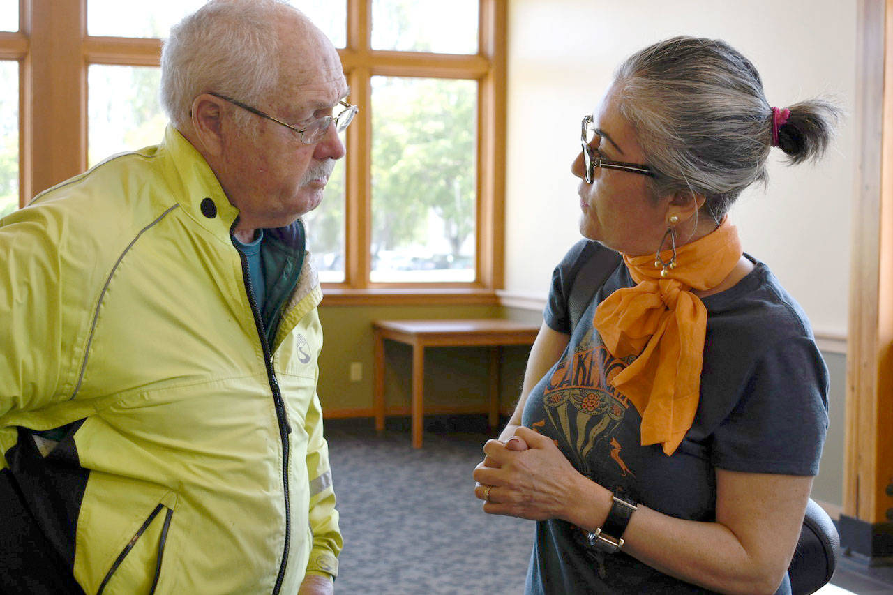 Port Townsend City Council member and real estate broker Michelle Sandoval talks with George Yount, former manager of the Port of Port Townsend, about housing after her presentation to the Jefferson County Chamber of Commerce. (Jeannie McMacken/Peninsula Daily News)