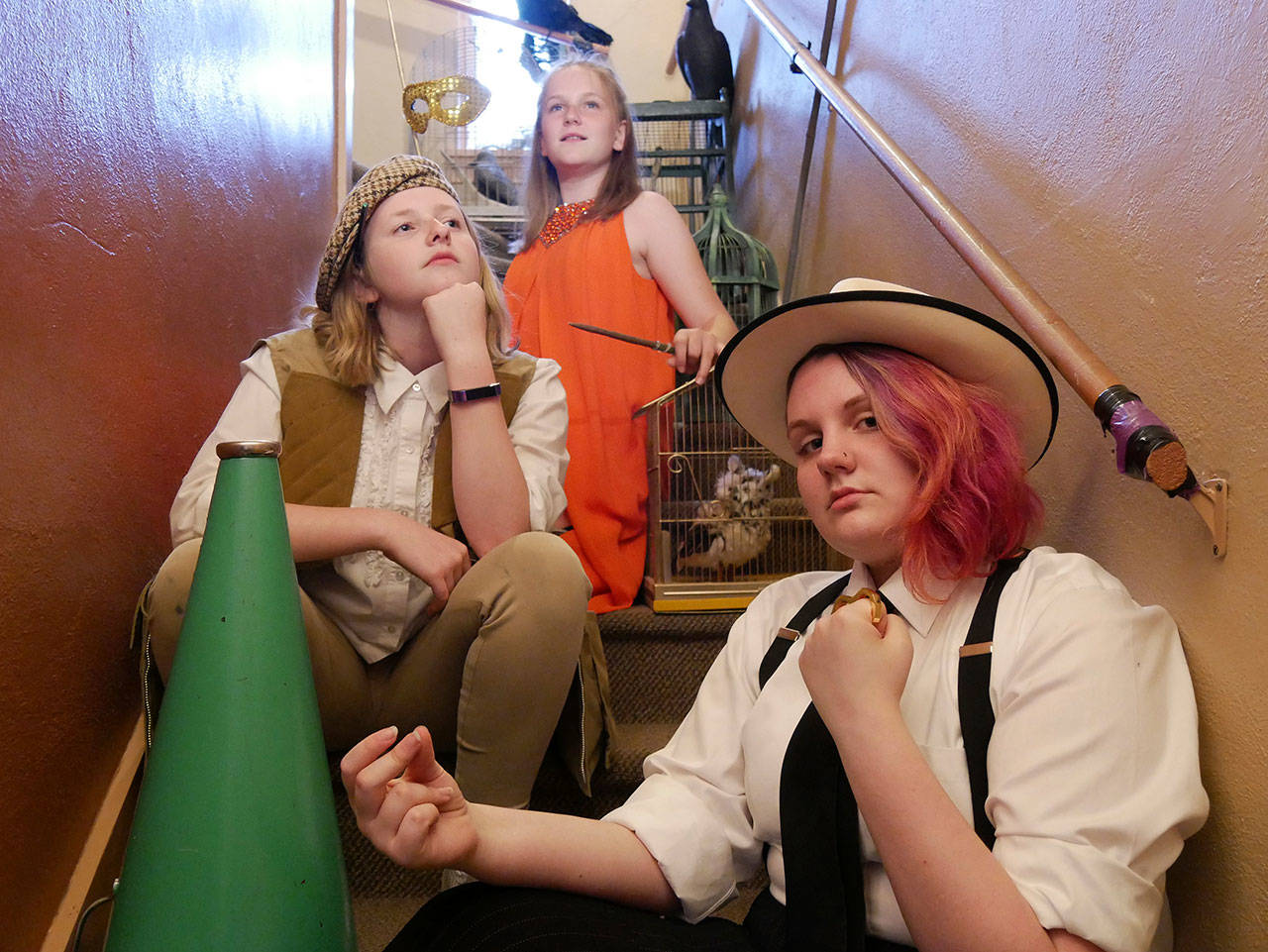 Starchild Academy members gather on the staircase to the “Aviary,” one of the many re-invented areas of Olympic Theatre Arts for the academy’s performances tonight and Saturday. They include, from left, Ruby Coulson, 12, (“Founder of the House of Directors”), Abby Sanford, 13, (“Founder of the House of Acting”) and Amélie Mantchev, 13, (“Conery Desecrets”).
