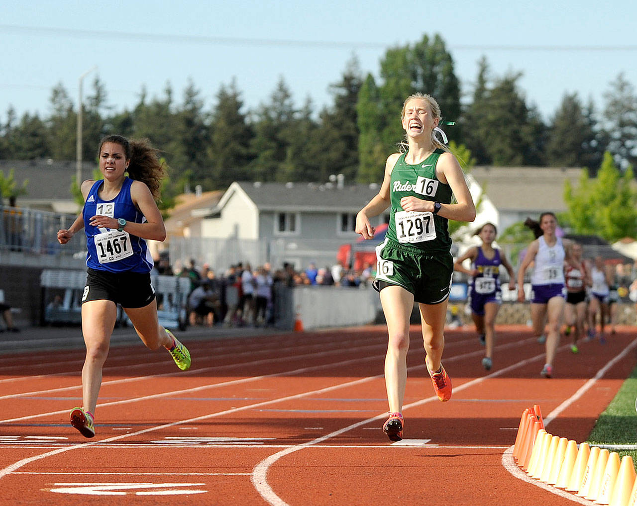 Port Angeles’ Gracie Long, right, reacts after winning the 1,600 meters at the state 2A Track and Field Championships at Mount Tahoma High School in Tacoma. At left is second place finisher Kristen Garcia of Sedro-Woolley. Long won with a personal-best time of 4:58.72. (Michael Dashiell/Olympic Peninsula News Group)